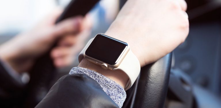 Apple watch on someone's wrist as they are driving