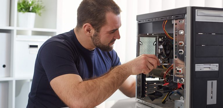 Man screwing something into a computer