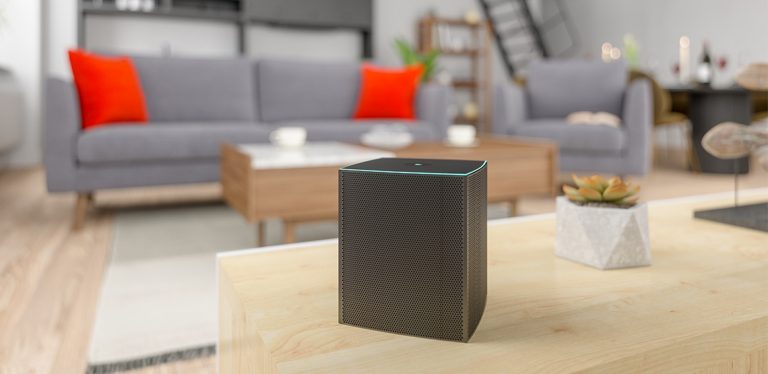 Wireless speaker sitting on a coffee table in a living room