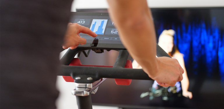Person on exercise bike with a screen