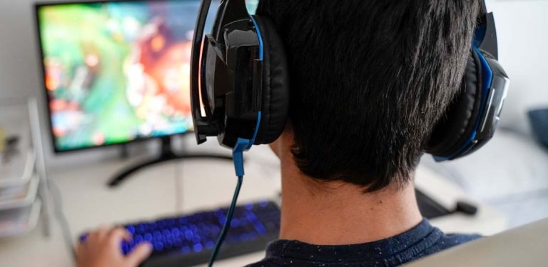Someone wearing headphones playing an online game.