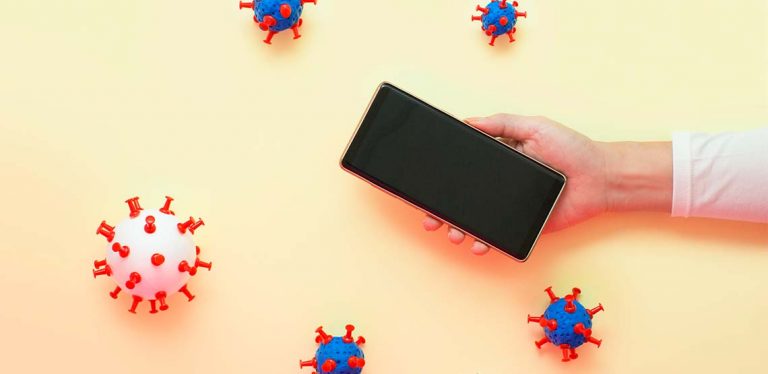 A black smart phone against a yellow screen with germ graphics around it.